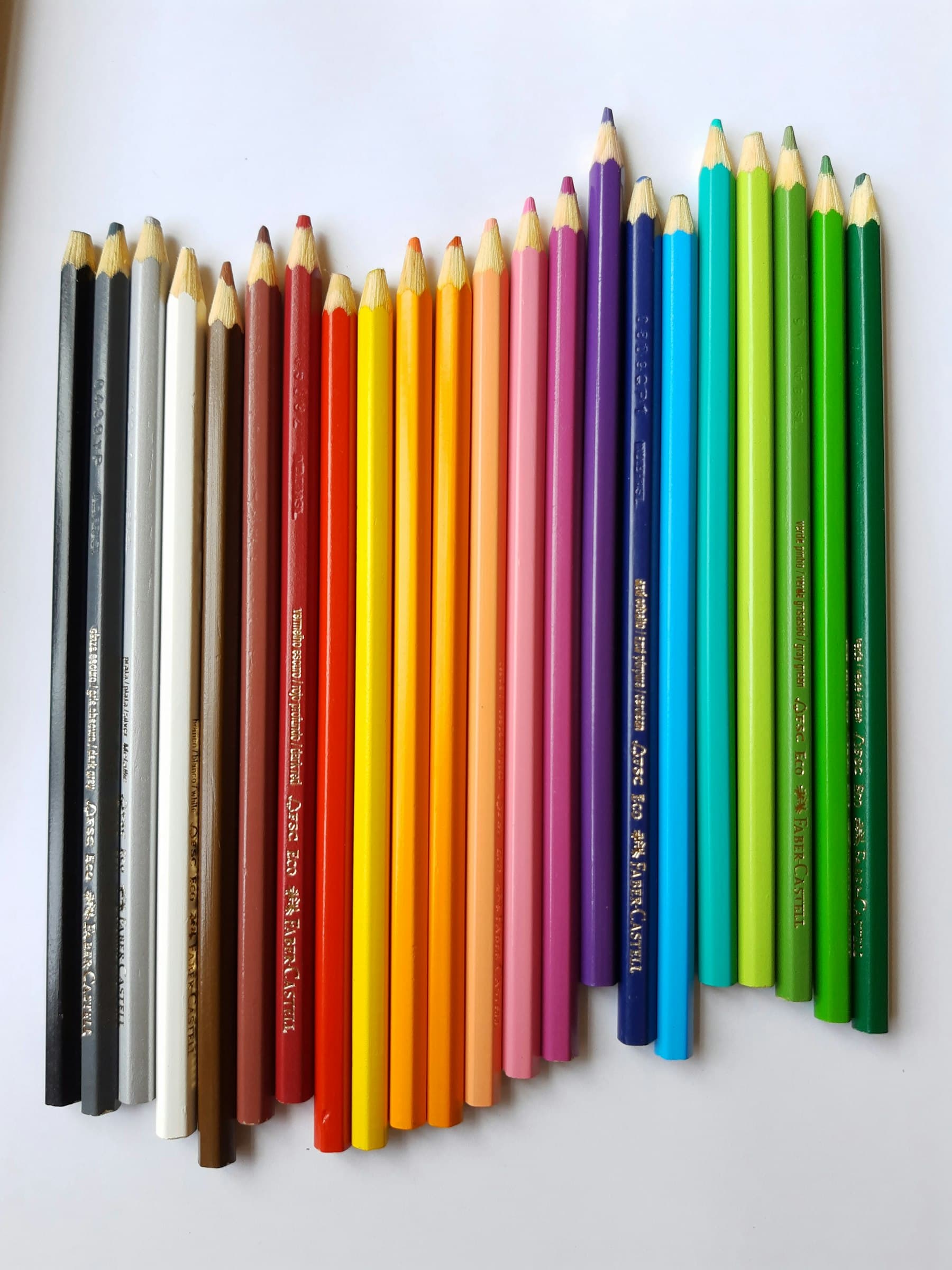 A row of coloured pencils arranged side by side across the full spectrum