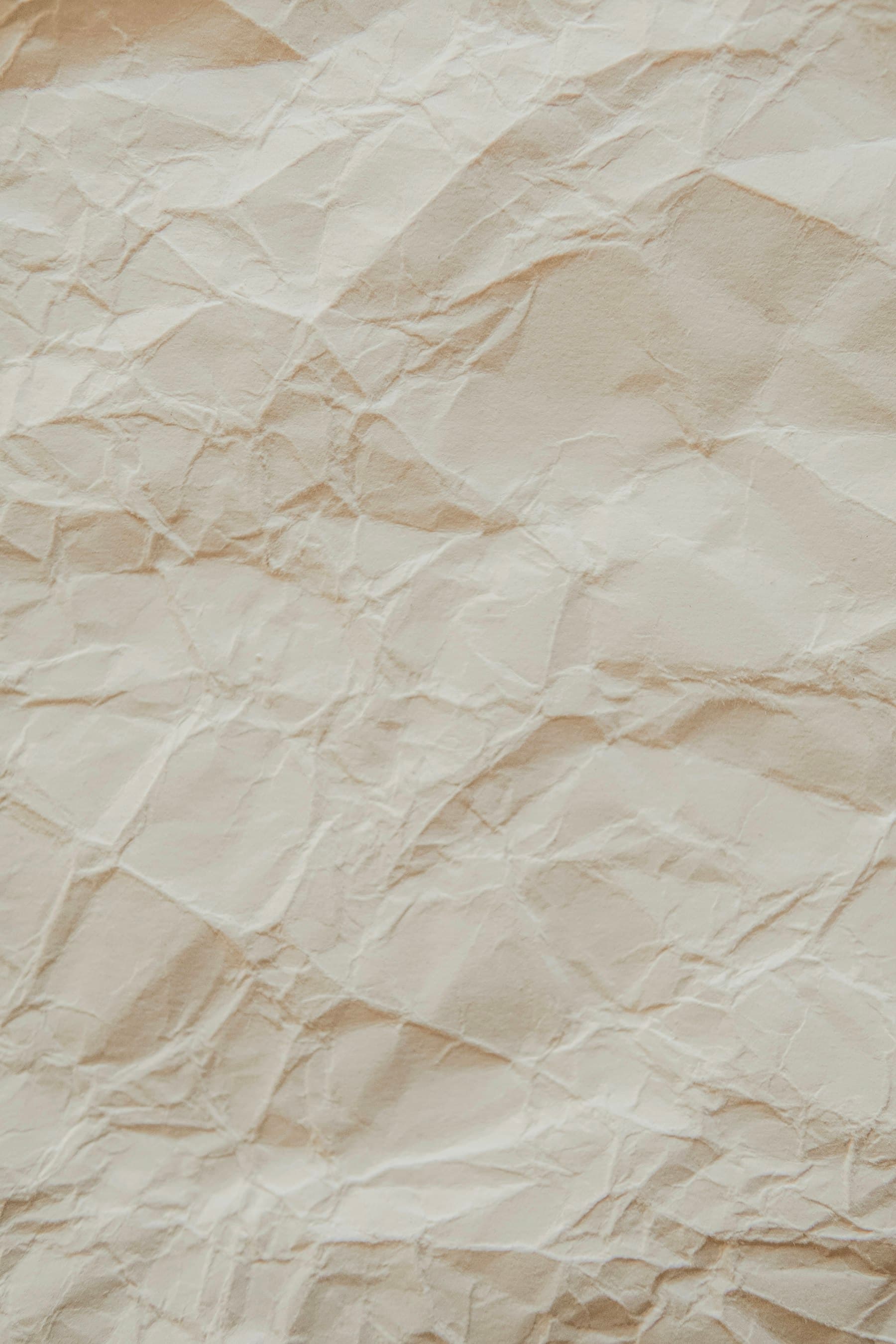 Close-up of creased off-white paper texture