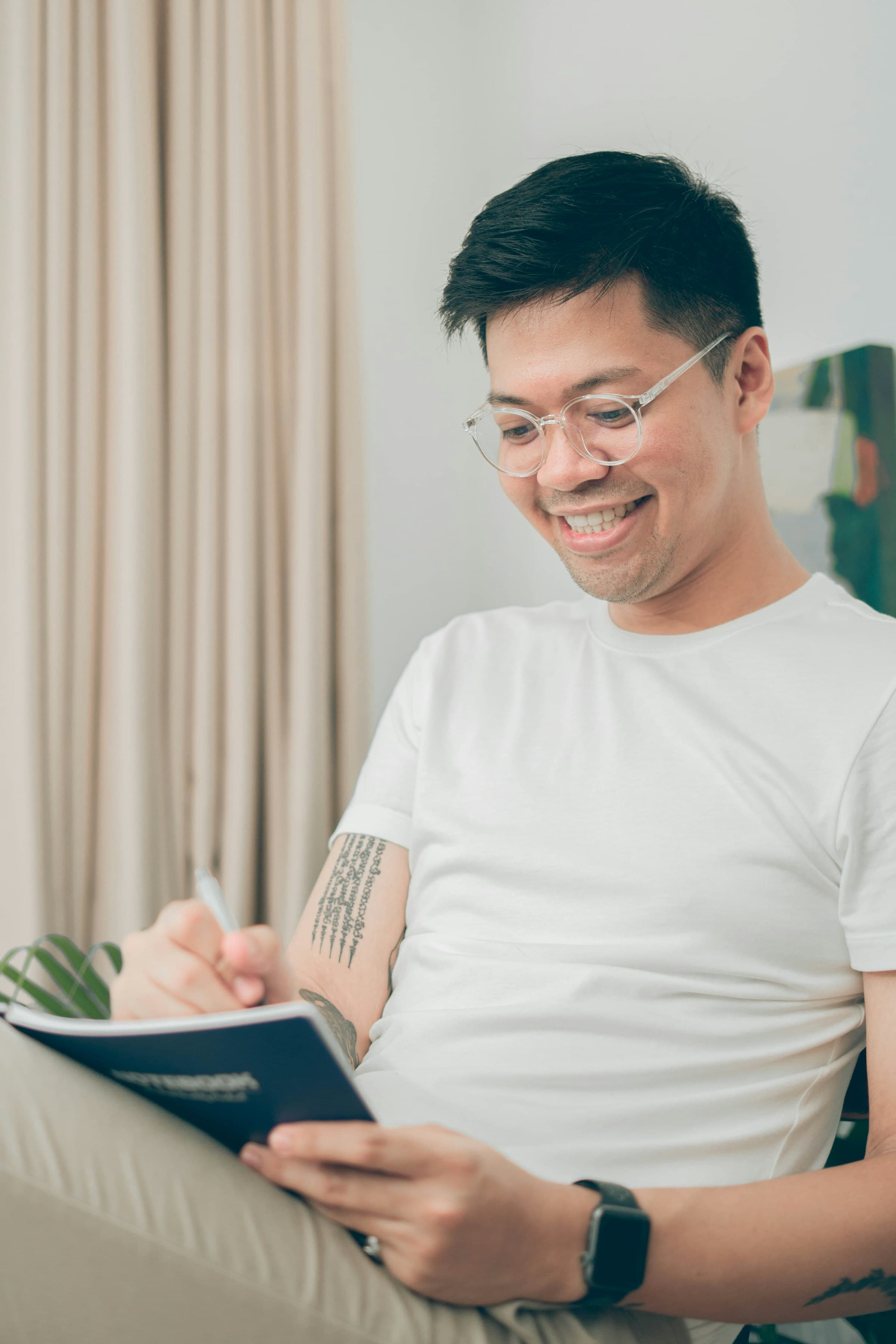A man working with a tablet and a notebook side by side